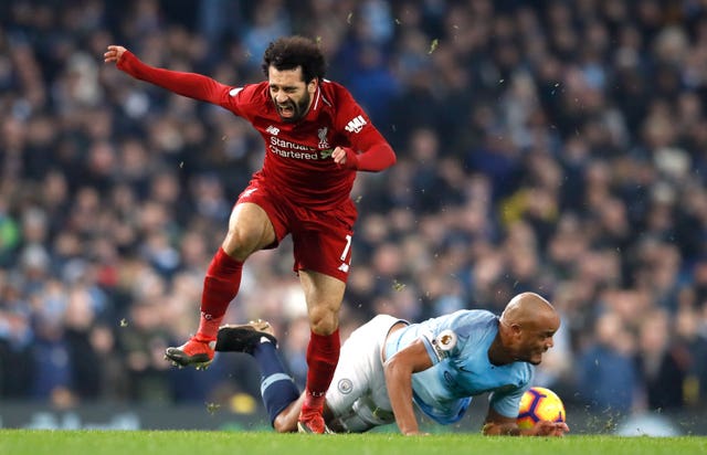 Mohamed Salah and Vincent Kompany vie for the ball at the Etihad