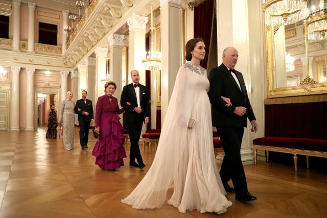 Kate is escorted into dinner by King Harald V of Norway and William is escorted by Queen Sonja of Norway at the Royal Palace in Oslo in 2018