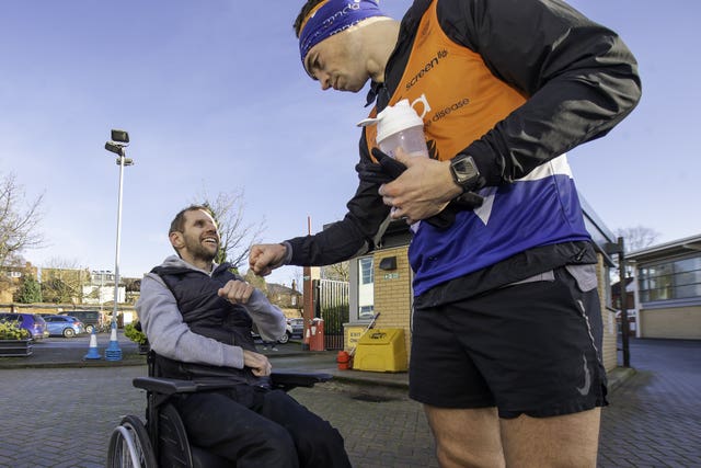 Rob Burrow greets his friend Kevin Sinfield at the end of one of the 7 in 7 marathons 