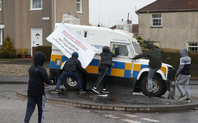 Youths attacking police vehicles at the unregistered parade in the Creggan (Niall Carson/PA)