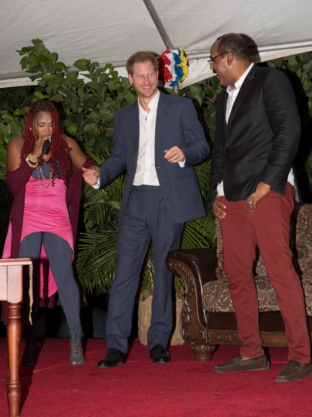 Prince Harry dances as Antigua and Barbuda's Prime Minister Gaston Browne watches during a 2016 Caribbean tour. (Paul Edwards/The Sun)