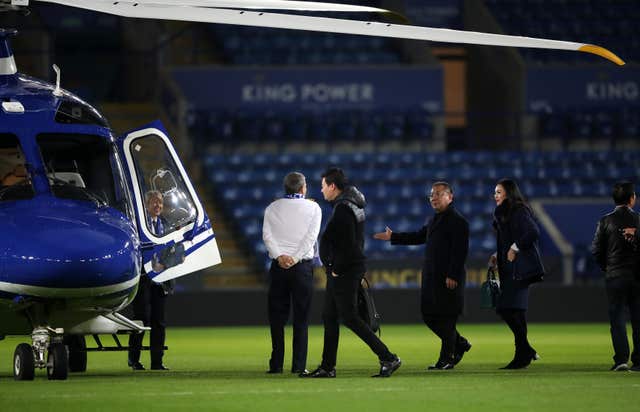 Leicester City chairman Vichai Srivaddhanaprabha (third right, holding out hand) getting into a helicopter after a match at the King Power Stadium in February last year (PA)