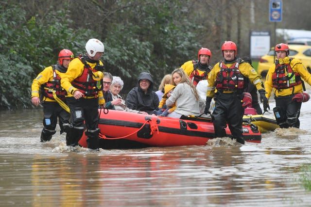 Members of the public are rescued after flooding in Nantgarw, Wales