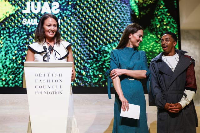 Caroline Rush addresses the audience as Kate talks with Saul Nash