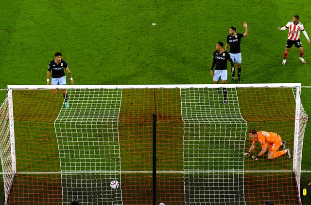 Aston Villa goalkeeper Emiliano Martinez (bottom right) looks on as Sheffield United’s David McGoldrick scores