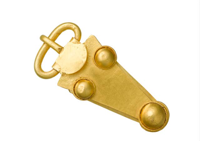 A gold belt buckle discovered in the burial chamber