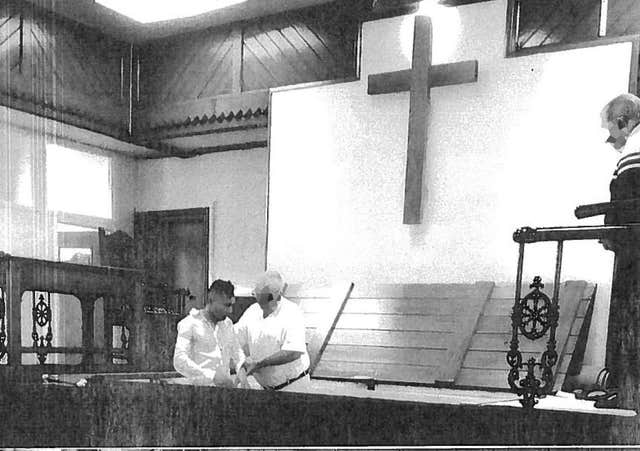 Abdul Ezedi, left, being baptised