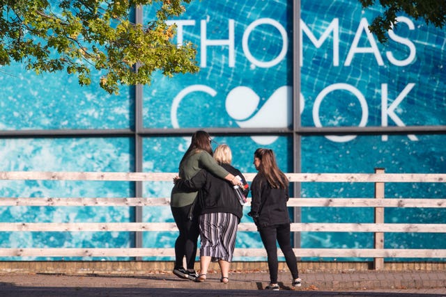 People outside the Peterborough headquarters of tour operator Thomas Cook