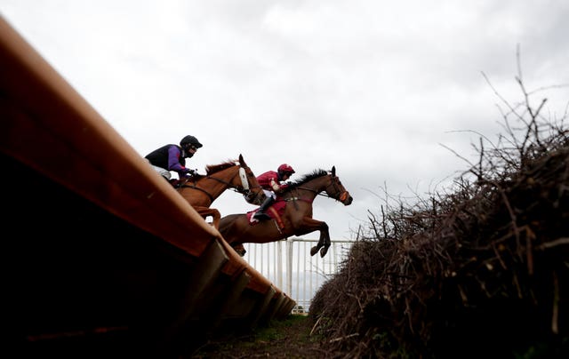 The Two Amigos ridden by Matt Griffiths (right) takes a jump during The Anne Duchess Of Westminster Memorial Handicap Chase at Bangor