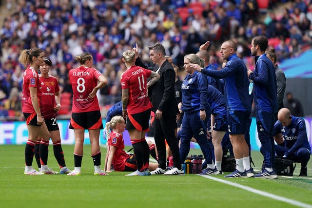 Manchester United manager Marc Skinner (centre) gives instructions to his team