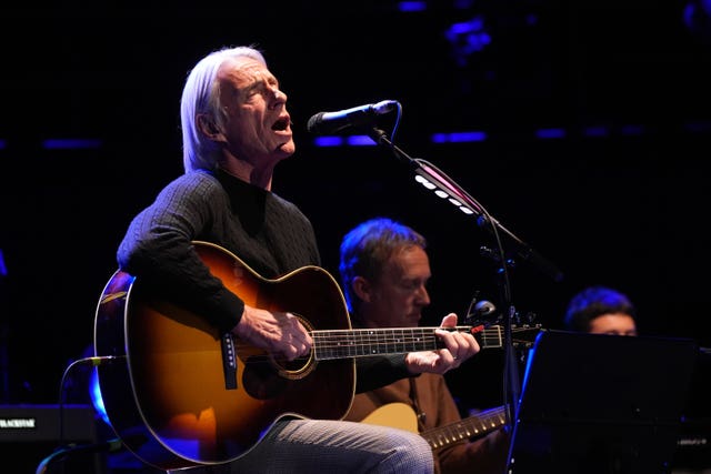 Paul Weller performing on stage
