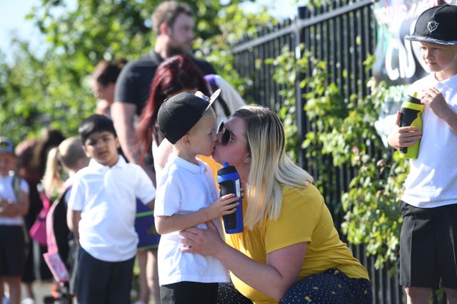 Parents drop off children at school