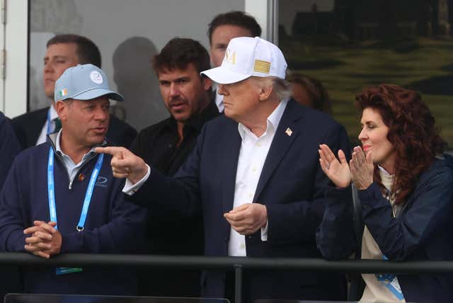 Donald Trump watches Rory McIlroy finish his round