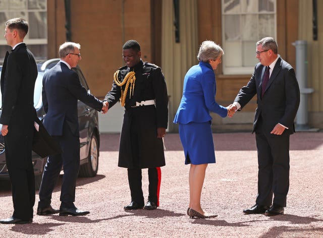 Theresa May arrives at Buckingham Palac
