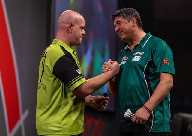 Michael Van Gerwen, left, edged a classic encounter against Mensur Suljovic