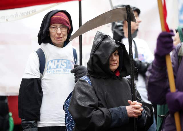 A protester dressed as the Grim Reaper (Yui Mok/PA)