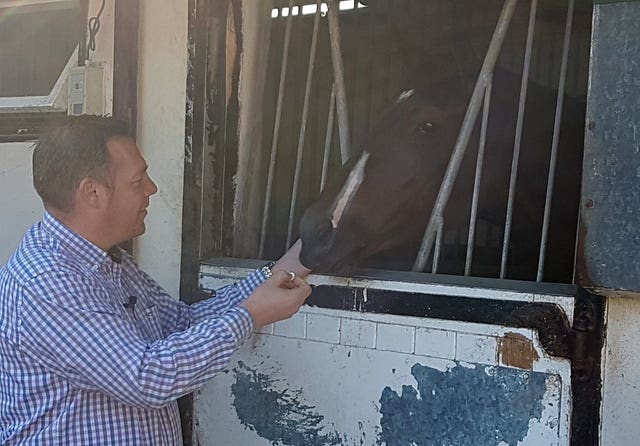 Owner John Dance gives Laurens a sweet in her box at Karl Burke’s yard in Leyburn