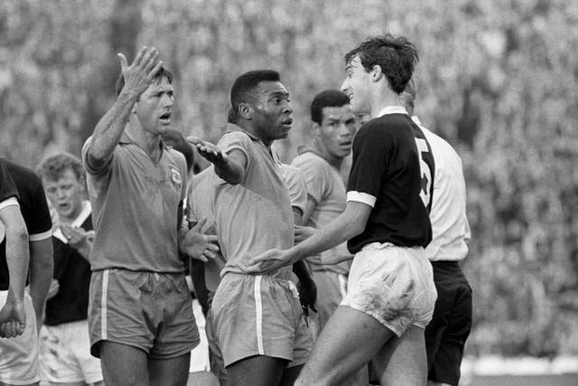 Pele (c) remonstrates with Scotland’s Ronnie MacKinnon