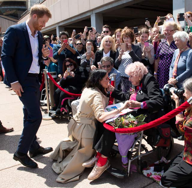 The Duke and Duchess of Sussex meet 98 year old Daphne Dunne during a walkabout outside the Sydney Opera House  (Paul Edwards/The Sun/PA)