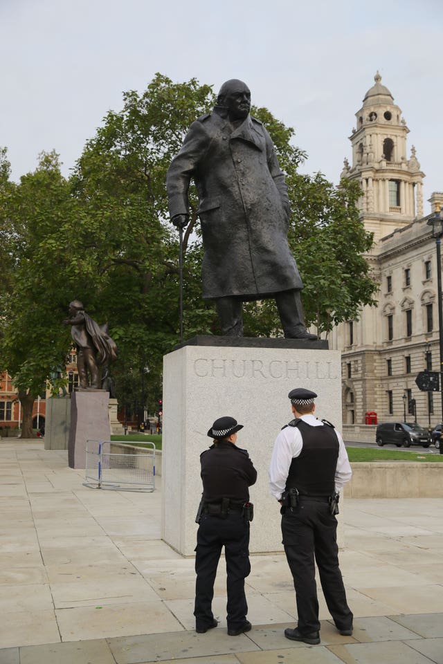 Police officers by the Winston Churchill statue in Parliament Square