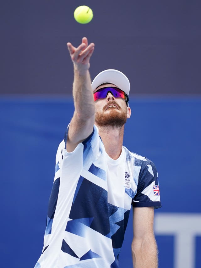 Jamie Murray throws the ball up to serve