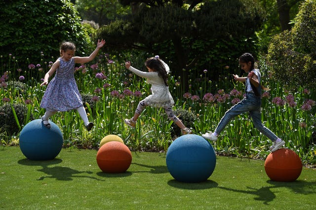Children jumping between balls