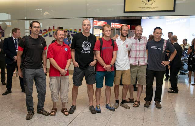 Divers from the rescue mission arriving back at Heathrow Airport after their mission