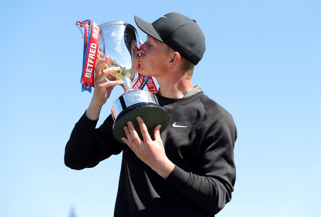 Marcus Kinhult kisses the trophy after winning the British Masters 