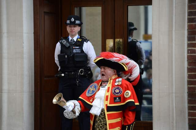 A town crier outside the Lindo Wing at St Mary's Hospital in Paddington, London, after the news that the Duchess of Cambridge has given birth to a son. (Kirsty O'Connor/PA)
