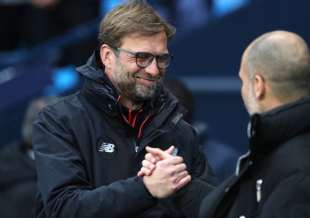 Guardiola (right) and Klopp (left) have a friendly rivalry