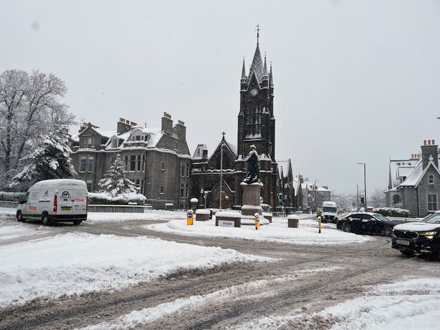 Vehicles driving on a snowy road in Aberdeen