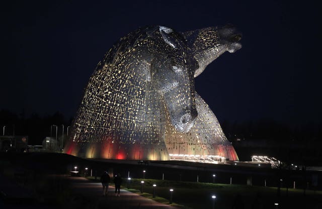 The Kelpies in Falkirk, Central Scotland, as they are lit up yellow during the National Day of Reflection, on the anniversary of the first national lockdown to prevent the spread of coronavirus