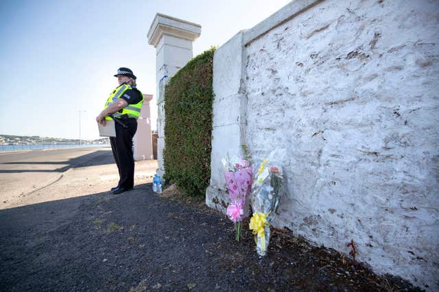 Floral tributes near a house on Ardbeg Road on the Isle of Bute