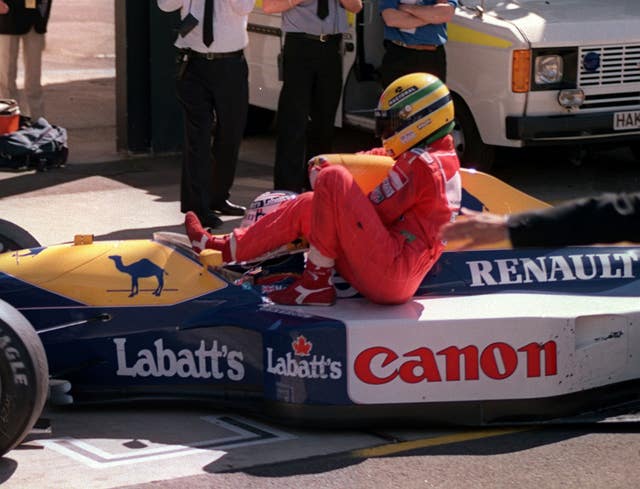 Ayrton Senna hitches a ride on Nigel Mansell's Williams Renualt after he ran out of fuel on the last lap of the British Grand Prix at Silverstone