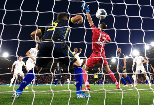 Raheem Sterling, centre, scores against Kosovo