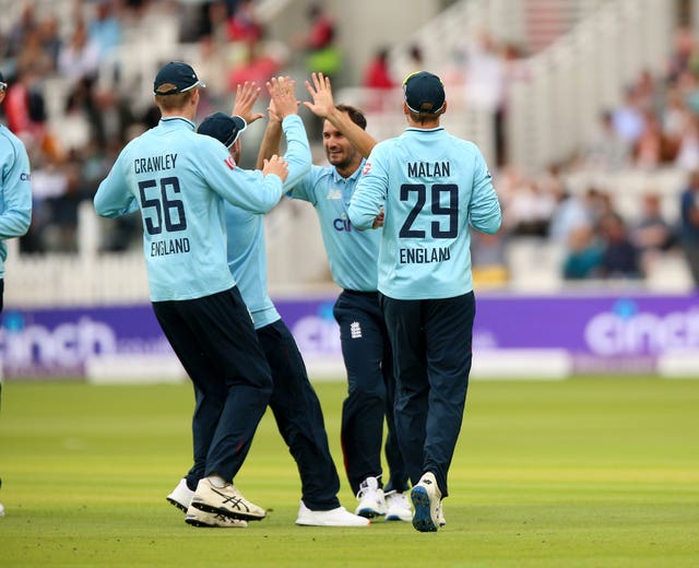 Lewis Gregory (centre) claimed three wickets and scored 40 runs for England