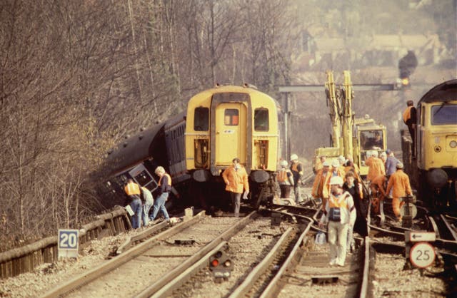Carriages hang over the rail embankment (Martin Keene/PA)