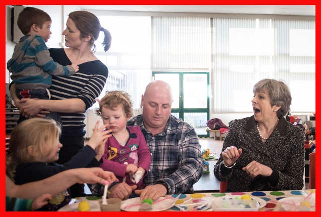 Prime Minister Theresa May joins in the fun with  a parent and toddler group at St Andrew’s Heddon-on-the-Wall, CofE Primary School in Newcastle (Stefan Rousseau/PA)