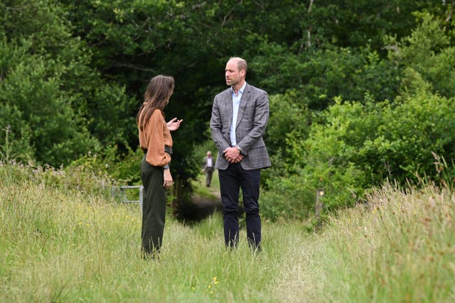 Managing director Rachel Phillips and the Prince of Wales as they stand among the long grass on the 120-acre farm