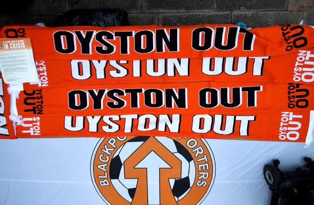 Oyston Out scarves are layed out in protest