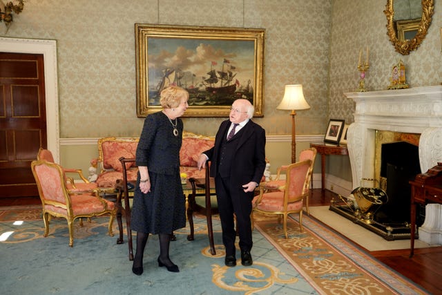 Michael D Higgins and his wife Sabina talking while standing in a drawing room
