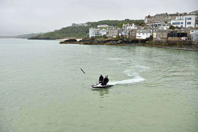 Police officers on a jet ski patrol the bay in St Ives during the G7 summit in Cornwall