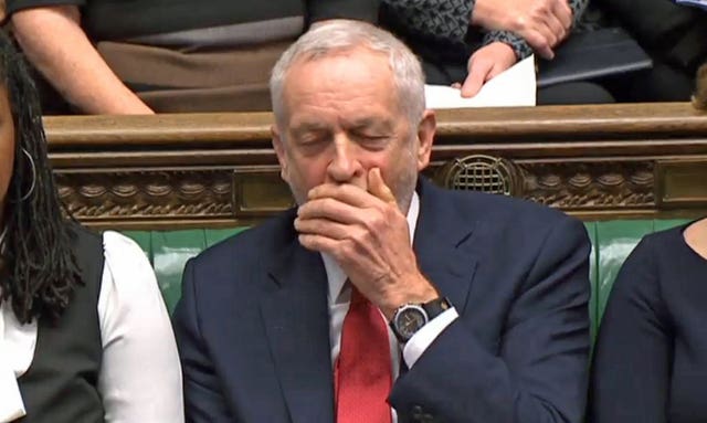 Labour party leader Jeremy Corbyn pretends to yawn during Prime Minister's Questions in the House of Commons