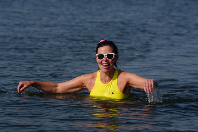 A woman going for a morning swim in Clontarf, Dublin