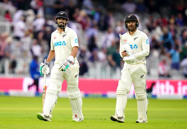 Daryl Mitchell (left) and Tom Blundell leave the field
