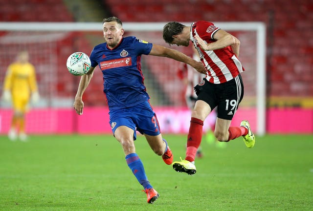 Charlie Wyke and Sheffield United's Richard Stearman battle for the ball 