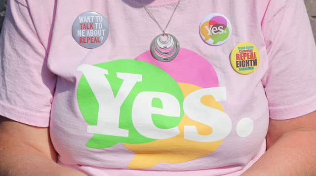 Yes badges on the T-Shirt of Liz Crummie, as the result is announced at Dublin Castle (Niall Carson/PA)