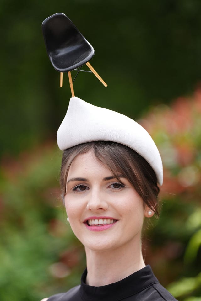 Woman wearing a chair hat