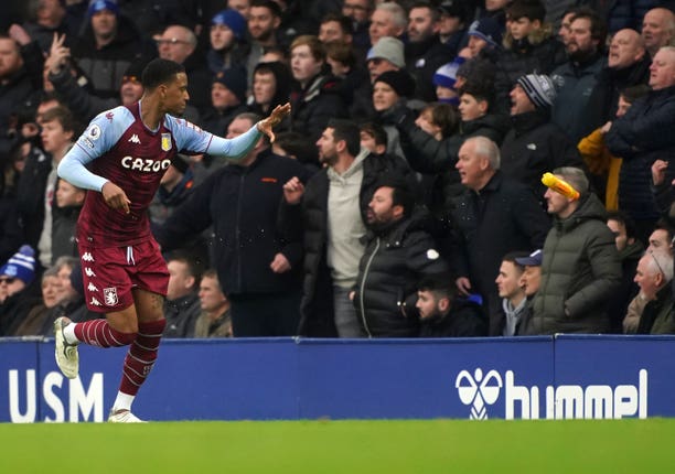 Aston Villa's Ezri Konsa tosses a bottle to the touchline after it was thrown onto the pitch