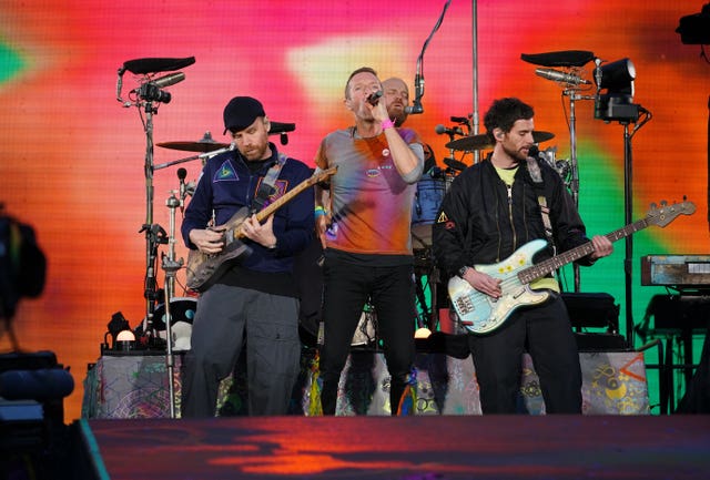 Coldplay performing on stage